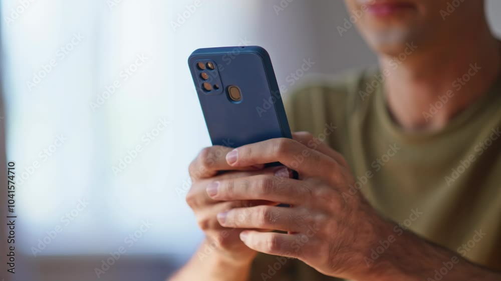 Closeup man hands texting cellphone in apartment. Businessman reading email Closeup man hands texting cellphone in apartment. Businessman reading email