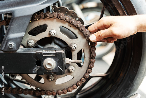 Motorcycle mechanic check motorcycl chain for wear and stretch, Maintenance and repair motorcycle concept