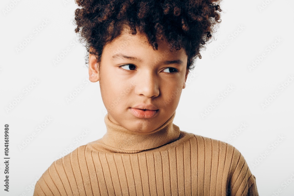 Young african american girl with afro hair gazing intently at the camera against a crisp white background Young african american girl with afro hair gazing intently at the camera against a crisp white background