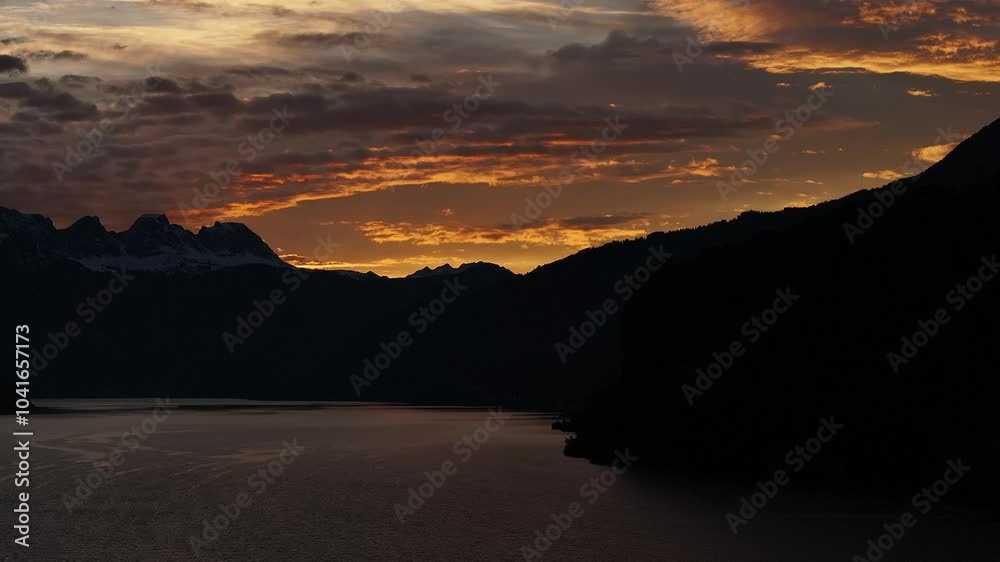 Sunset over Lake Walensee with the silhouette of the Swiss Alps in the background. Drone 4k. Sunset over Lake Walensee with the silhouette of the Swiss Alps in the background. Drone 4k.