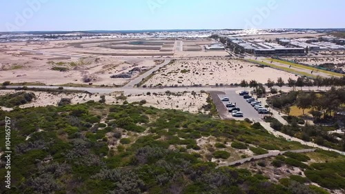 Dolly right clip of Shorehaven waterfont park and earthworks for housing development in background photo