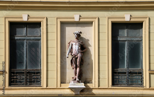 A fragment of the historicism architectural facade with a sculpture of Mercury photo