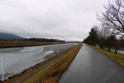 Winter landscape along the river with green grass and trees,  photo