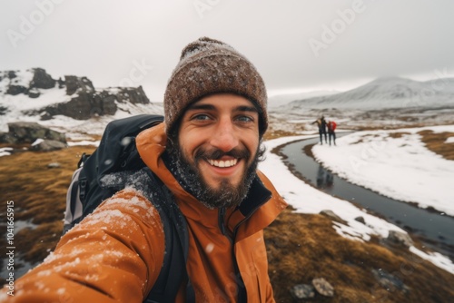 Selfie view of happy men hiking with beautiful natural landscape while snowing in Iceland