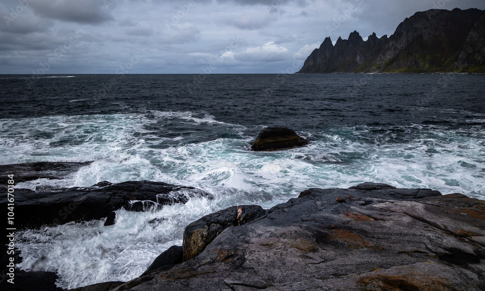 Obraz premium Ocean waves crushing on the rocky Tungeneset beach, Senja, Norway. Seasonal scenery of Scandinavia.