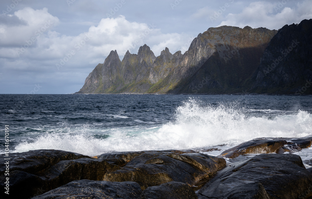 Obraz premium Ocean waves crushing on the rocky Tungeneset beach, Senja, Norway. Seasonal scenery of Scandinavia.