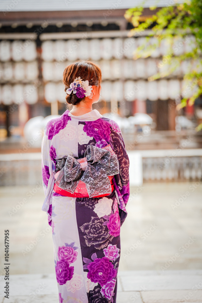 Woman in Kimono Walking Towards Shrine with a flower on her head. Kyoto Japan. Japanese traditional architecture background. Woman in Kimono Walking Towards Shrine with a flower on her head. Kyoto Japan. Japanese traditional architecture background.