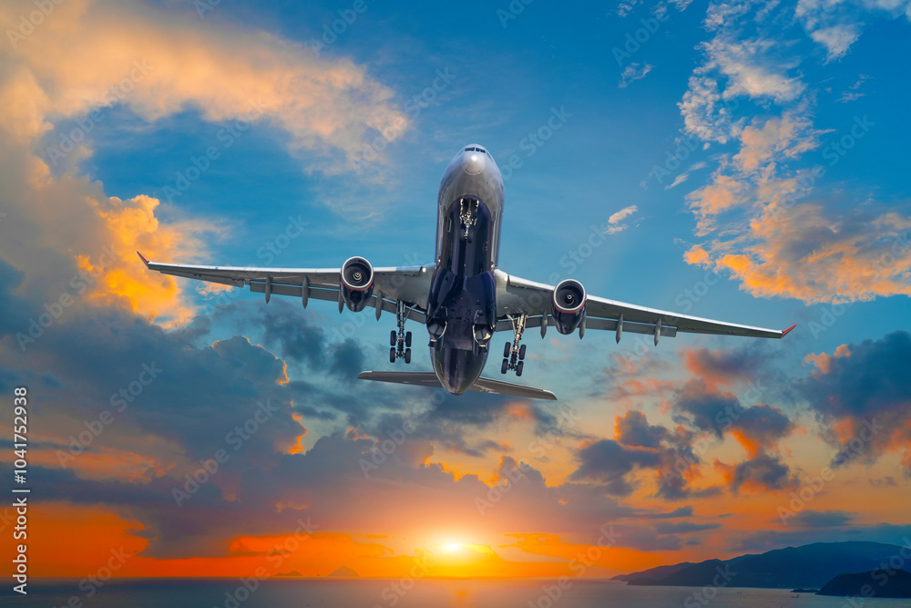 Airplane flying into the orange dawn sun tropical sunset background. Vacation, adventure and love concept Airplane flying into the orange dawn sun tropical sunset background. Vacation, adventure and love concept