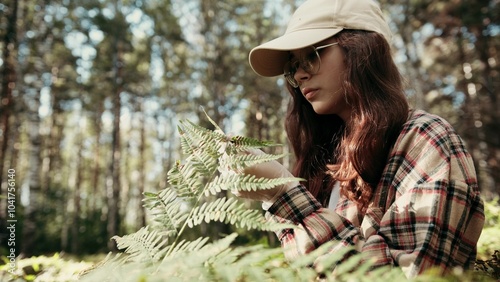 Photos Exploring Nature A Young Woman Engaged with Forest Ferns in a Scenic, Peaceful L