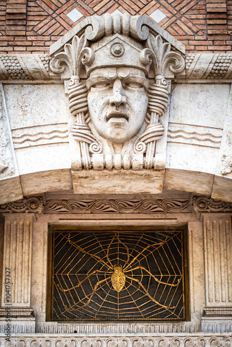 Mascherone di Pietra e Ragno sul Palazzo del Ragno nel Quartiere Coppedè, Art Déco, Roma photo