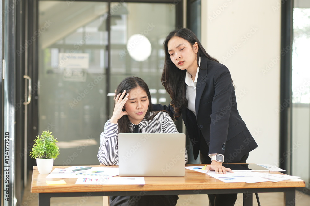 Asian woman stressed out working in the office Asian woman stressed out working in the office