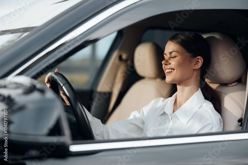 Woman, car, driver's seat, eyes closed, hands on steering wheel a woman sitting in the driver's seat of a car with her eyes closed and hands gently resting on the wheel, appearing calm and relaxed