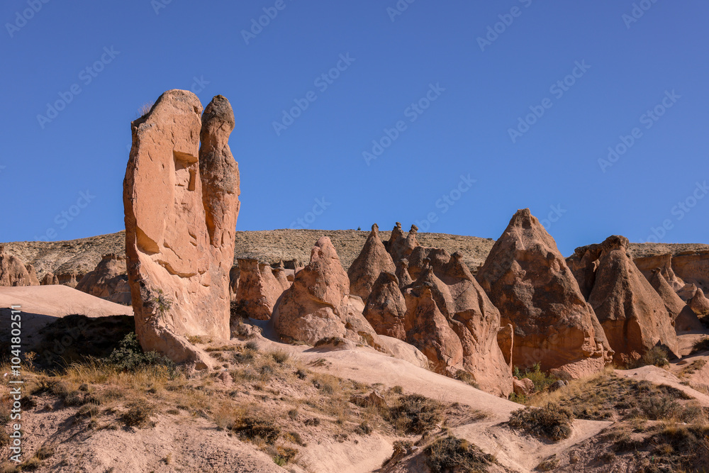 Unique rock formations in Cappadocia under a clear blue sky during the daytime Unique rock formations in Cappadocia under a clear blue sky during the daytime