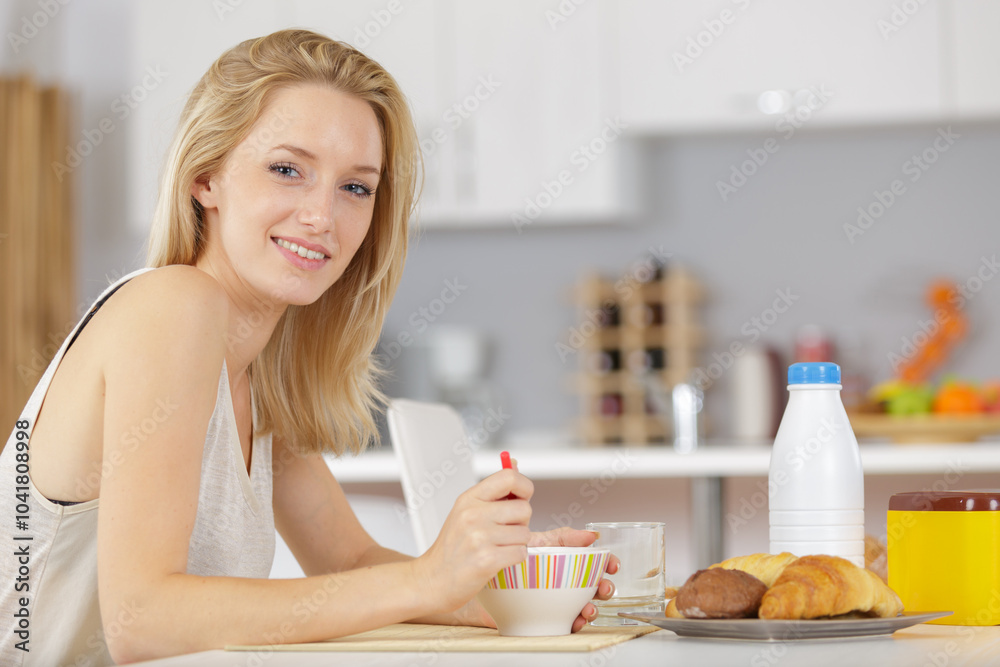 beautiful young blonde woman eating cereals in the morning beautiful young blonde woman eating cereals in the morning