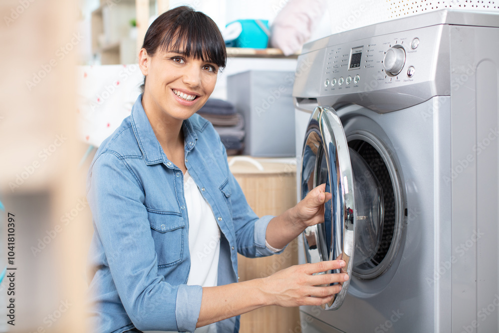 woman doing homework filling washing machine woman doing homework filling washing machine