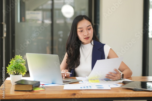 Asian woman stressed out working in the office