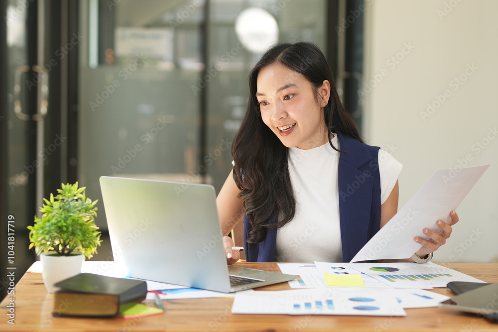 Happy Asian business people working together using laptop and tablet in office. Happy Asian business people working together using laptop and tablet in office.