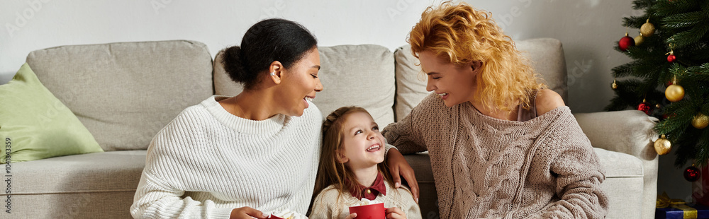 A loving couple shares a joyful moment with their daughter while cozying up at home. A loving couple shares a joyful moment with their daughter while cozying up at home.