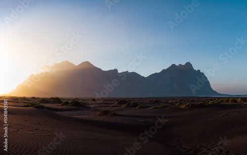 Obraz na płótnie Stunning panoramic view of Vestrahorn, an impressive 454 metres tall mountain. It faces out to the sea on its southern side and is surrounded by a black sandy coastline. Iceland. w salonie
