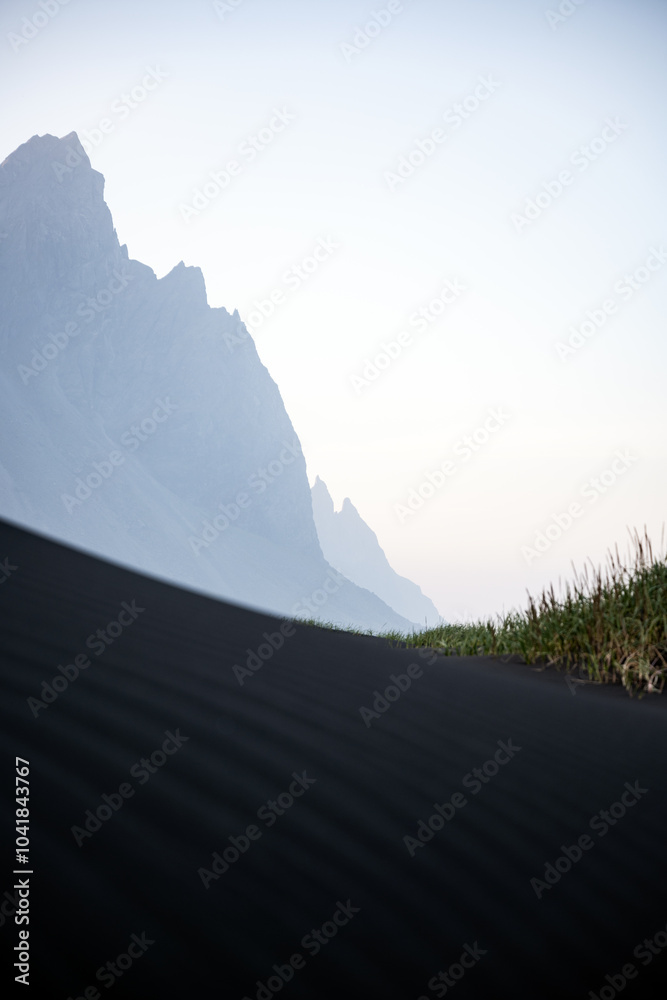 Stunning view of Vestrahorn at sunset with some black sand dunes in the foreground. Vestrahorn is an impressive 454 metres tall mountain. Iceland.