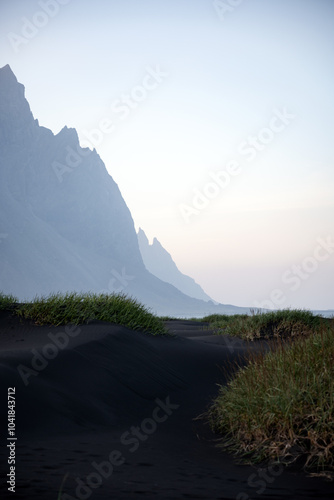 Obraz na płótnie Stunning view of Vestrahorn at sunset with some black sand dunes in the foreground. Vestrahorn is an impressive 454 metres tall mountain. Iceland. w salonie