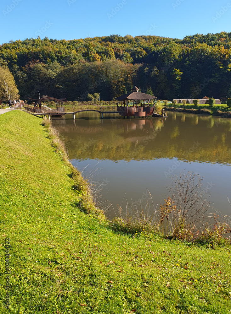 Fototapeta premium Autumn landscape, autumn forest reflected in the lake, golden autumn
