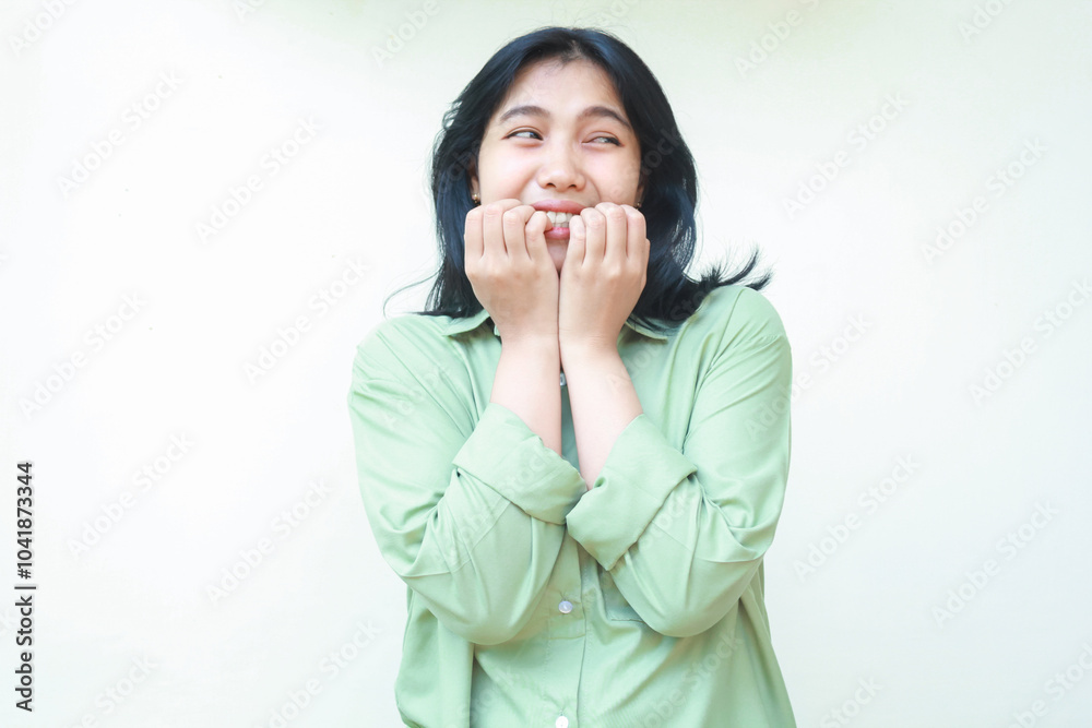 unhappy scared asian woman wearing green oversize shirt bite her nails feeling afraid and frightened looking aside to empty space thinking something standing isolated on white background unhappy scared asian woman wearing green oversize shirt bite her nails feeling afraid and frightened looking aside to empty space thinking something standing isolated on white background