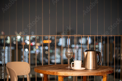 A scene from a blacony at night with table and glass and others photo