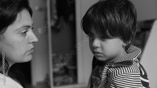 Mother and son having an emotional conversation. boy looks upset and teary-eyed while the mother listens carefully in a serious moment of communication, monochrome