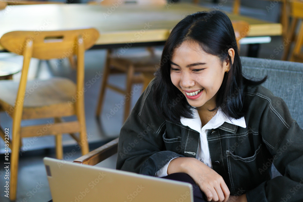 carefree asian woman using laptop in cafe doing virtual online meeting with client, browing social media and reading news carefree asian woman using laptop in cafe doing virtual online meeting with client, browing social media and reading news