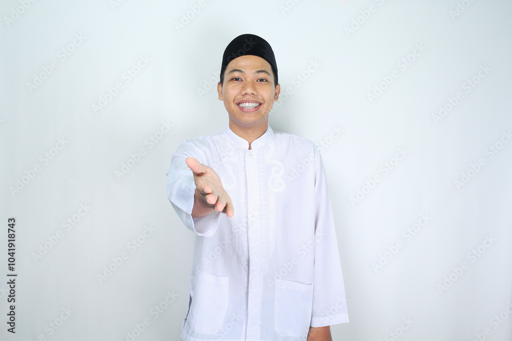 smiling asian muslim man offering handshake in eid mubarak celebration isolated on white background smiling asian muslim man offering handshake in eid mubarak celebration isolated on white background