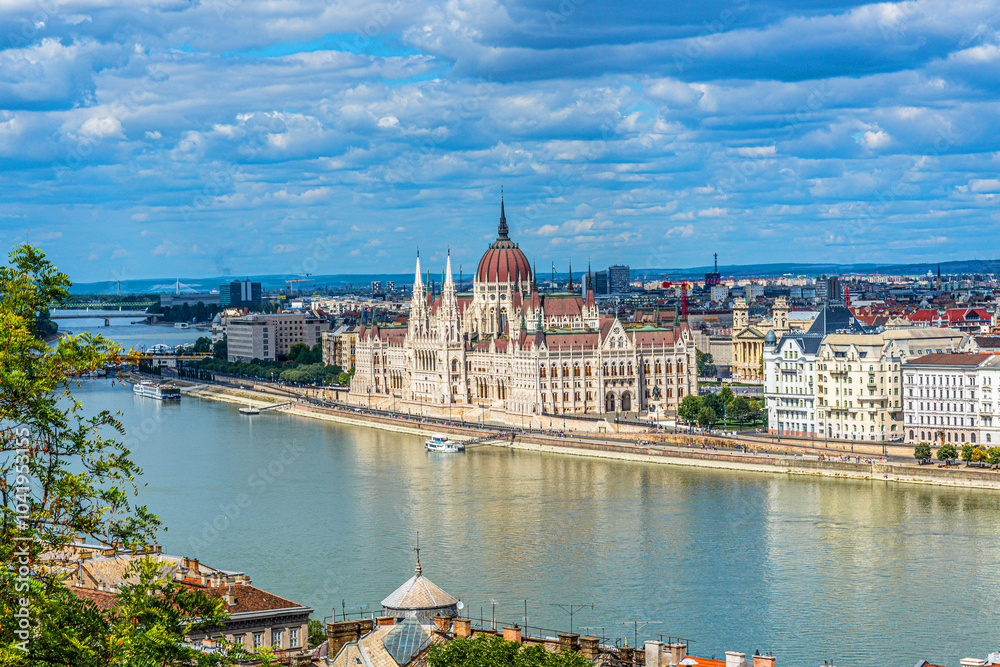 Naklejka premium View of the Hungarian Parliament Across the Danube River in Pest from Buda Castle in Budapest, Hungary.