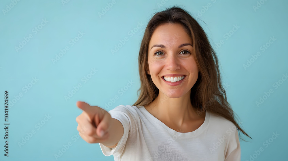 A smiling businesswoman points enthusiastically at something, showcasing a gesture of success and positivity