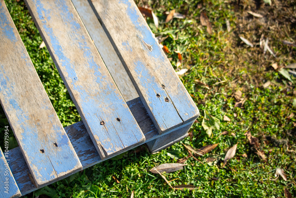 A wooden pallet is sitting on a grassy field A wooden pallet is sitting on a grassy field
