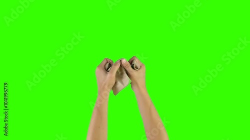 hands crumpling brown paper isolated on green screen background