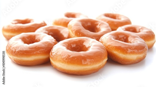 A close-up of glazed donuts stacked together, showcasing their smooth texture and appealing golden-brown color.