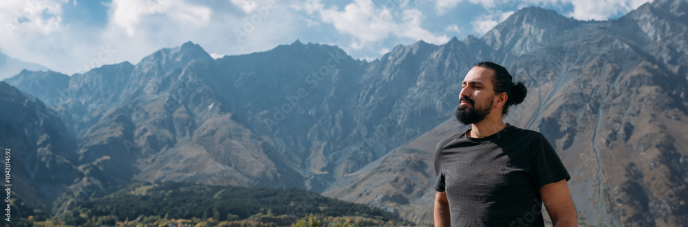 A man on the background of an autumn mountain landscape. A man on the background of an autumn mountain landscape.