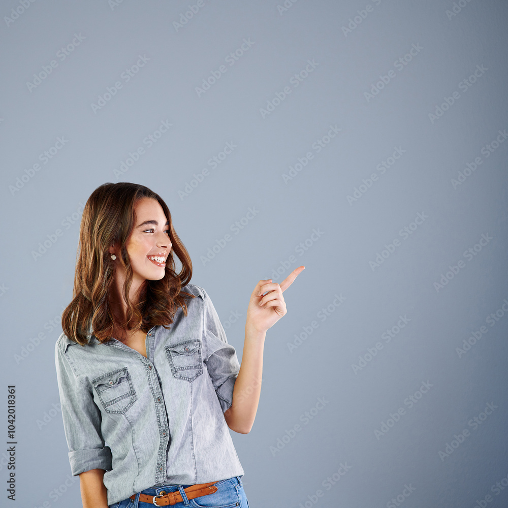 Girl, happy and point in studio with space for mockup with fashion, choice or smile for review by background. Woman, person and model with thinking for decision, feedback or excited with trendy style Girl, happy and point in studio with space for mockup with fashion, choice or smile for review by background. Woman, person and model with thinking for decision, feedback or excited with trendy style
