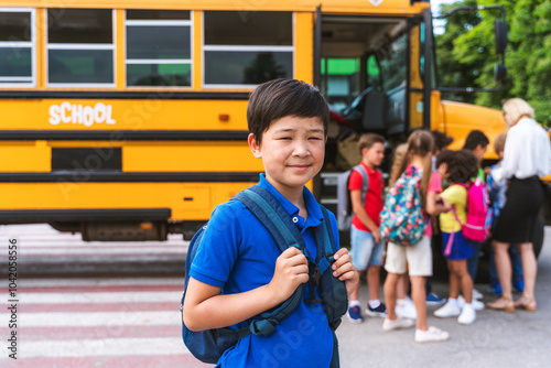 Group of young students attending primary school on a yellow school bus photo