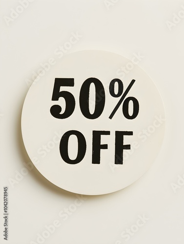 Black '50% OFF' Text on a Ivory Round Paper Note. White Background 