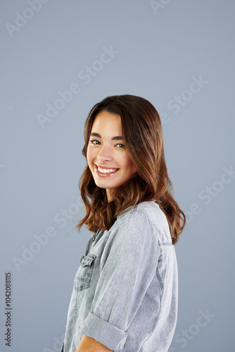 Happy, student and portrait of girl in studio with confidence, pride and smile for college. Mockup space, university and isolated woman for education, learning and studying on gray background