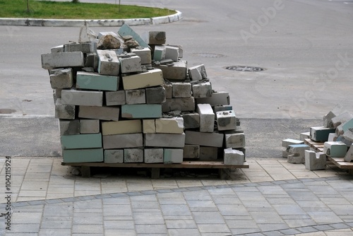 A stack of assorted bricks on pallets, showcasing different colors, outdoors, concept of construction materials photo