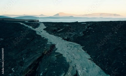 Wallpaper Mural shot with cool, morning tones: The camera starts with a close-up of a fault line in a rocky landscape. It then cranes upward to reveal the full extent of the fault line and the surrounding geological  Torontodigital.ca