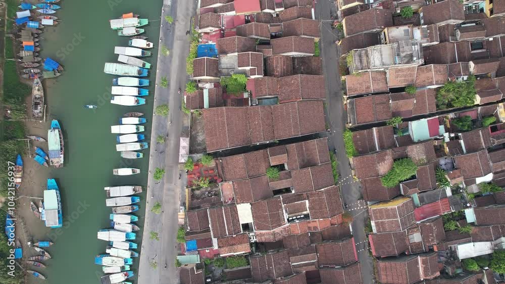 Aerial view of a traditional Asian coastal village with boats lined up on the river perfect for concepts of travel and cultural exploration Aerial view of a traditional Asian coastal village with boats lined up on the river perfect for concepts of travel and cultural exploration