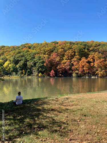 Woman meditating in Inwood Hill Park photo