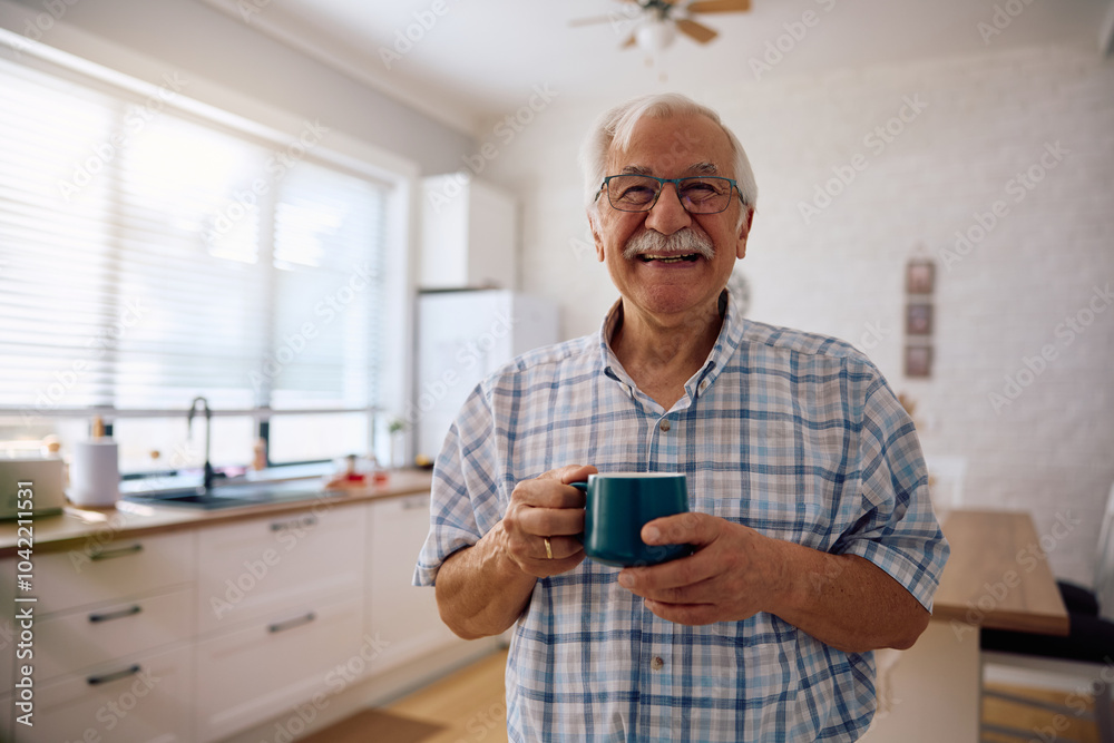 Portrait of happy senior man having cup of coffee at home and looking at camera. Portrait of happy senior man having cup of coffee at home and looking at camera.