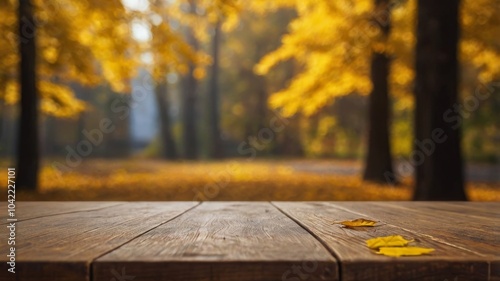 Obraz na płótnie Beautiful colorful natural autumn background for presentation. Fallen dry orange leaves on wooden boards against the backdrop of a blurry autumn park. w salonie