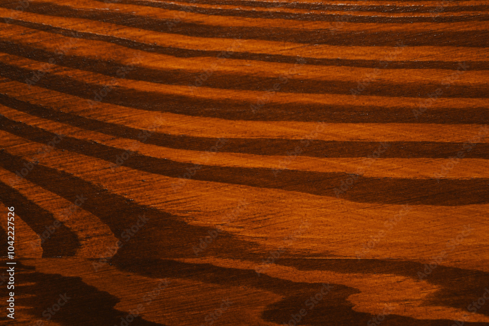 Naklejka premium Texture of wooden surface after applying walnut wood stain as background, top view