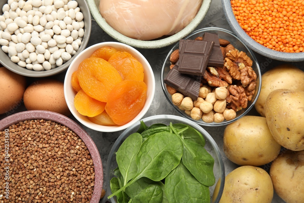 Different products rich in iron on grey table, top view. Diet plan for anemia Different products rich in iron on grey table, top view. Diet plan for anemia