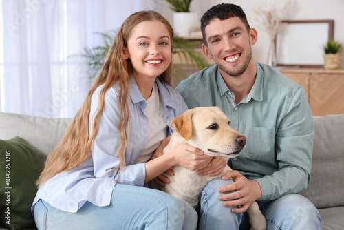 Happy young couple with Lab...